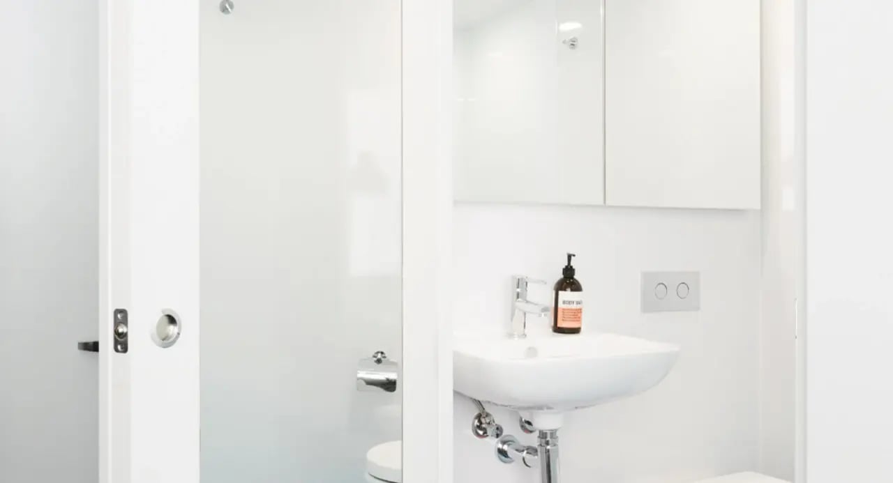 White sink soap dispenser flush plate toilet Bathroom at Scape South Bank in Brisbane Student Accommodation
