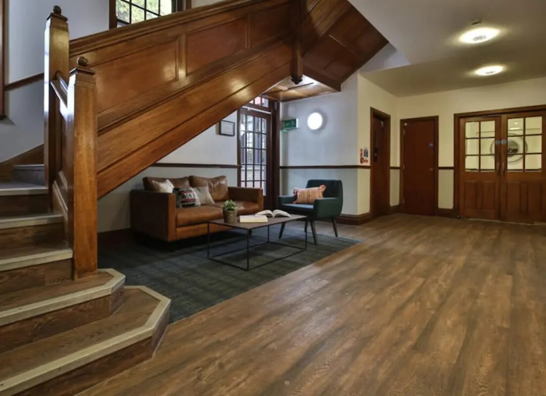 Leather sofas coffee table and chair living room at Halsmere Studios in London Student Accommodation