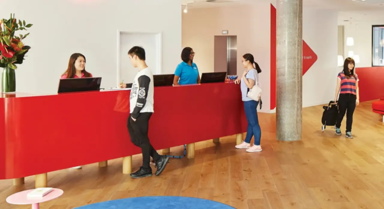 Reception desk with students and staff lobby at Scape South Bank in Brisbane Student Accommodation