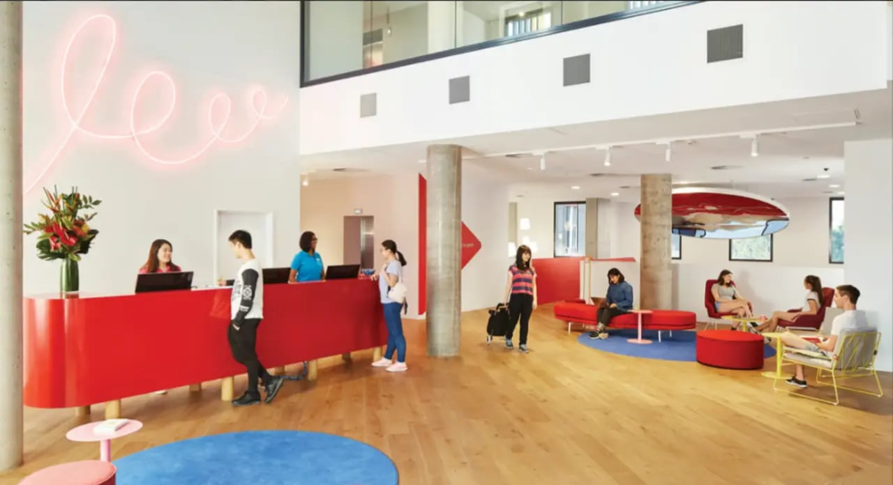 Reception desk people and lounge area reception at Scape South Bank in Brisbane Student Accommodation