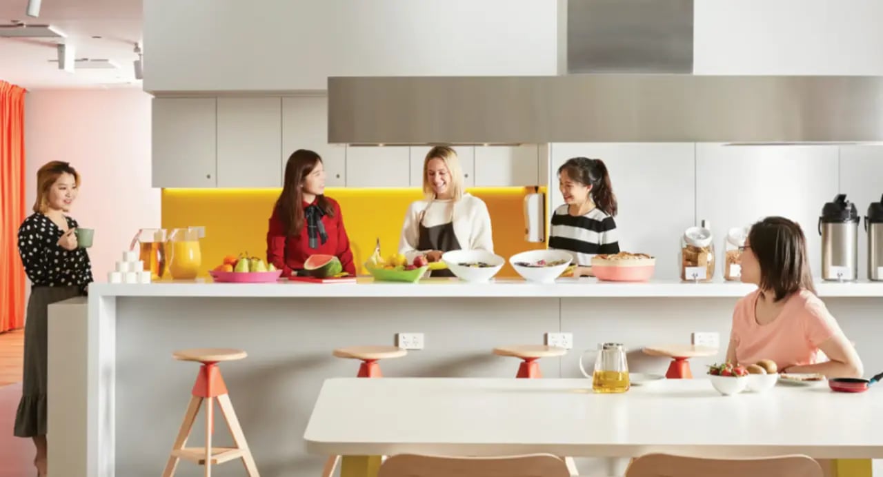 Students preparing food at kitchen counter with fruit kitchen at Scape South Bank in Brisbane Student Accommodation