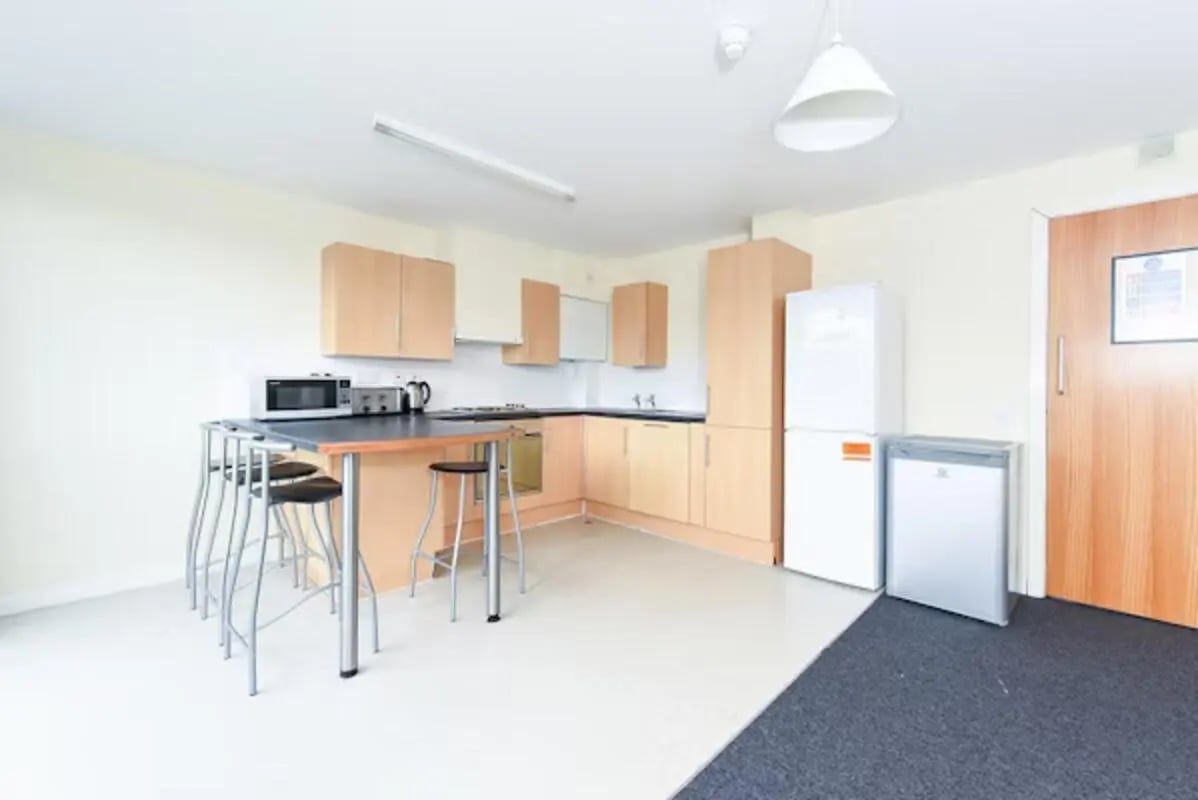 Kitchen with counter island fridge and stools kitchen at Gibson Street in Glasgow Student Accommodation