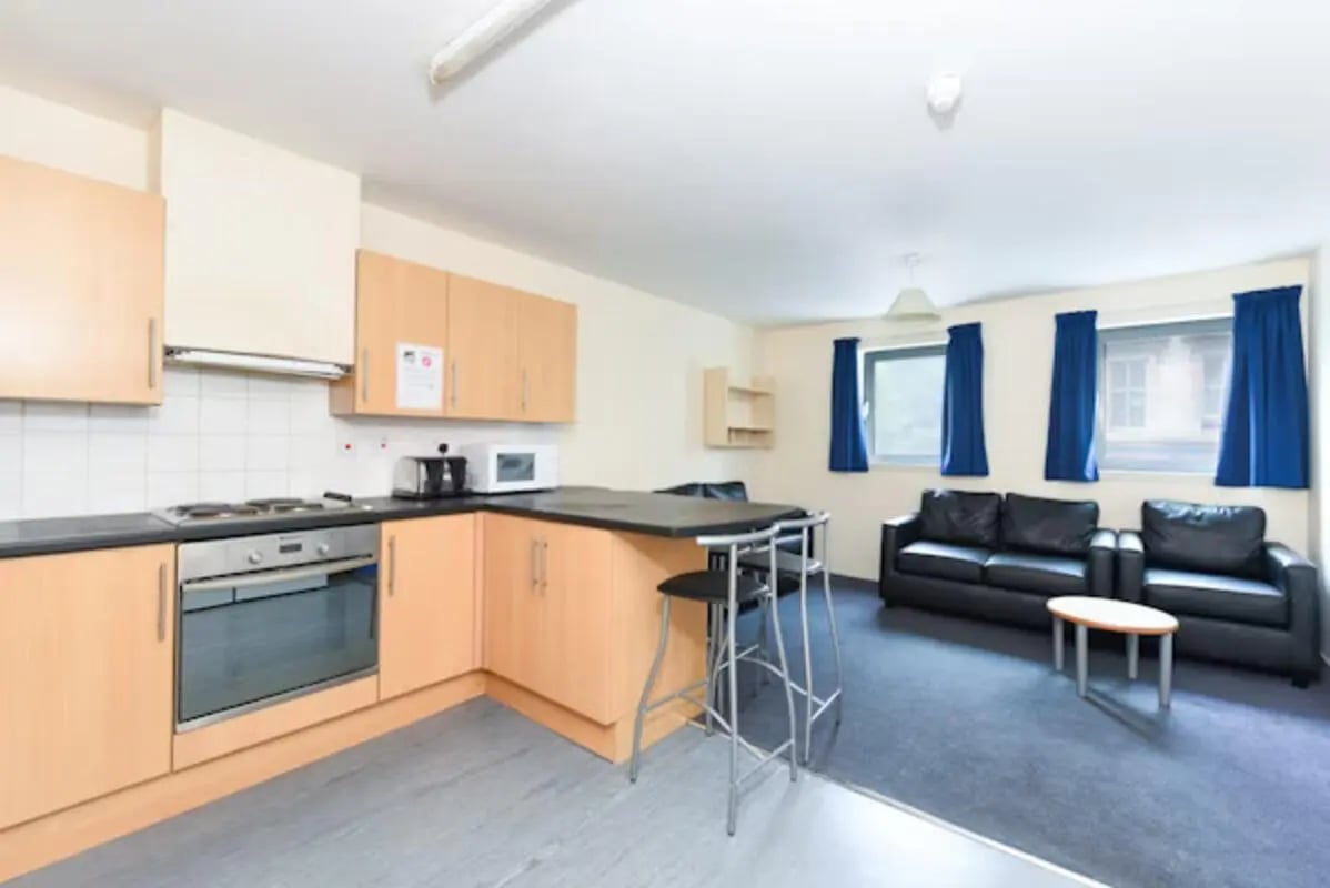 Kitchen with breakfast bar and living area living room at Gibson Street in Glasgow Student Accommodation