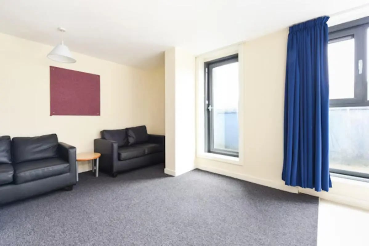 Two black sofas burgundy board living room at Gibson Street in Glasgow Student Accommodation