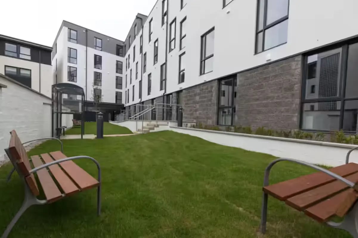 Benches grass building exterior and entrance at St Peter Studios in Aberdeen Student Accommodation