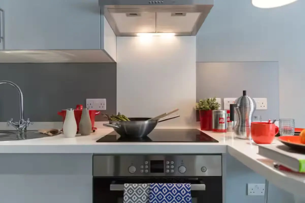 Stove top with asparagus in pan kitchen at St Peter Studios in Aberdeen Student Accommodation
