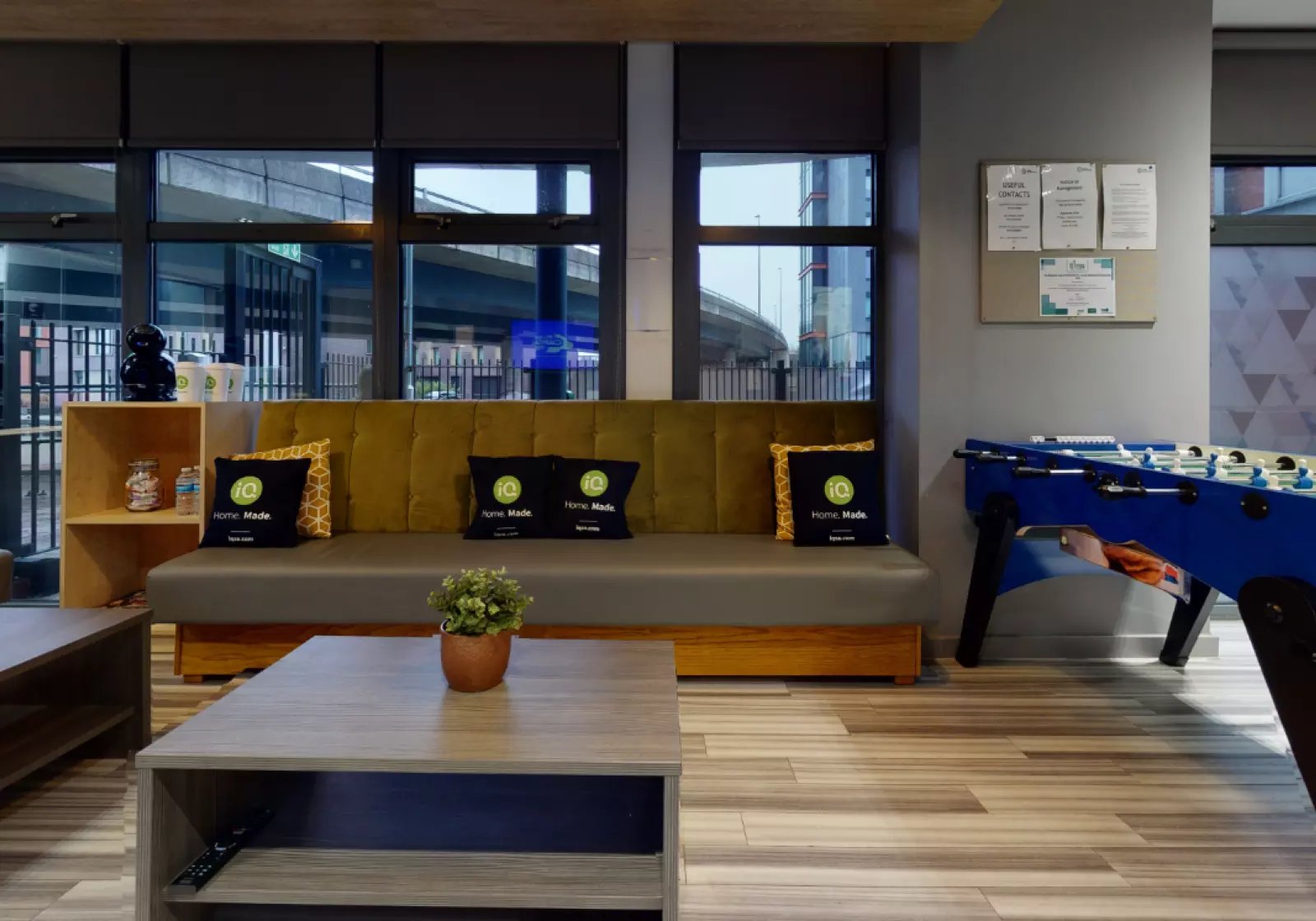 Sofa pillows plant foosball table living room at iQ Hayes Wharf in Lincoln Student Accommodation