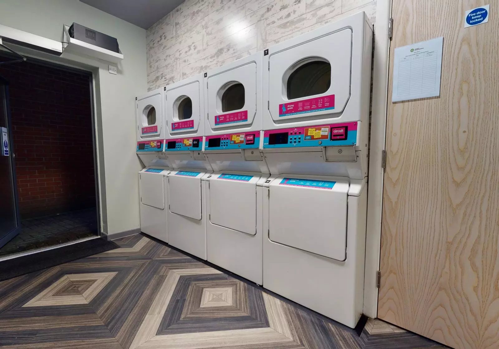 Multiple washing machines and dryers laundry area at iQ Hayes Wharf in Lincoln Student Accommodation