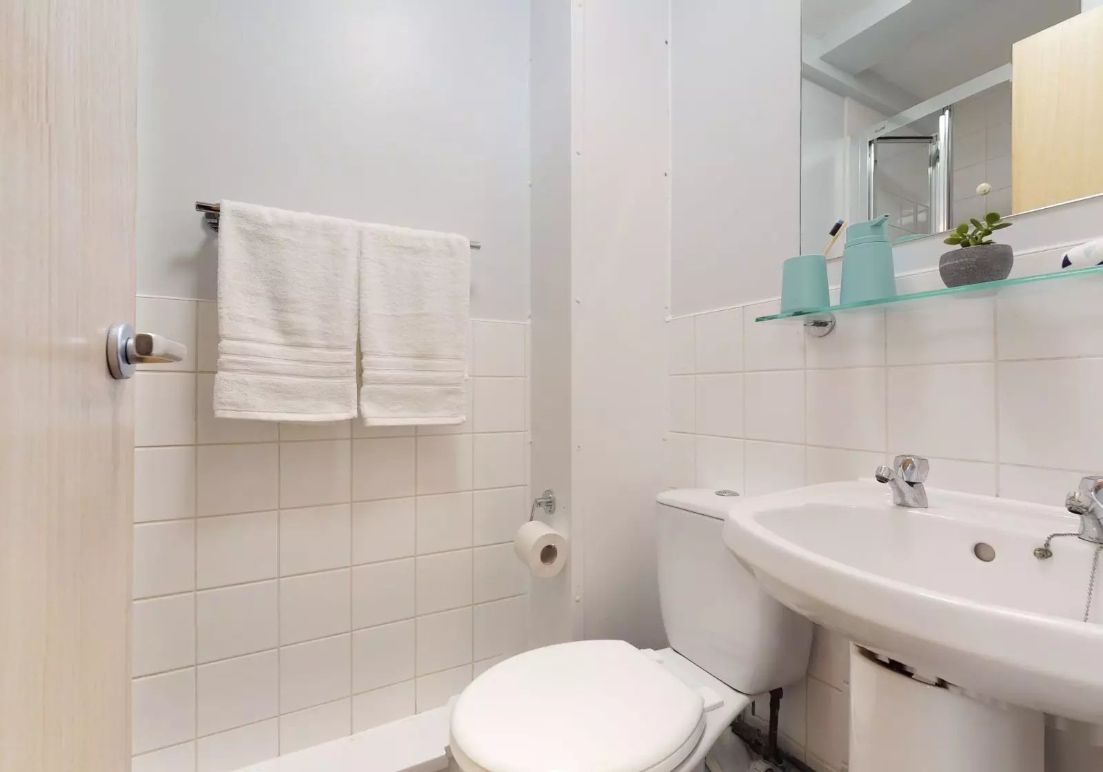 Toilet sink and towels in a student bathroom at iQ Hayes Wharf in Lincoln Student Accommodation