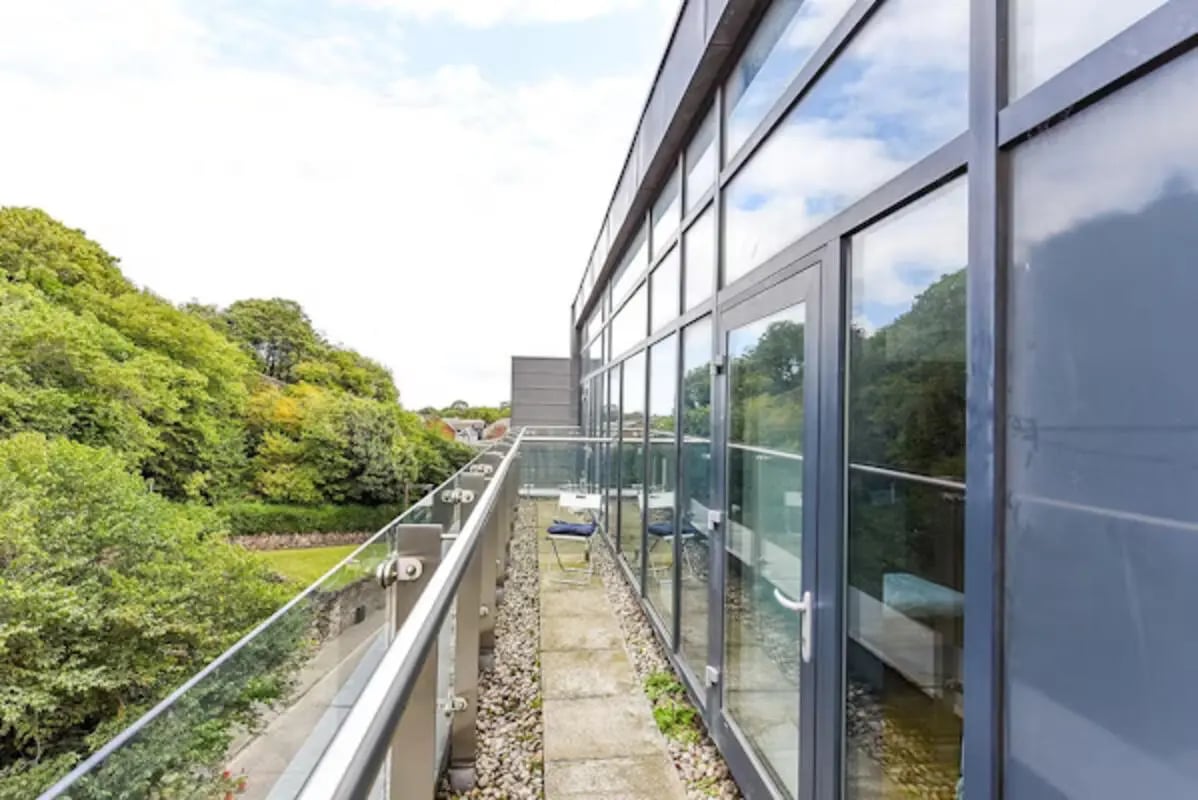 Balcony with chairs and glass railing exterior at Panmure Court in Edinburgh Student Accommodation