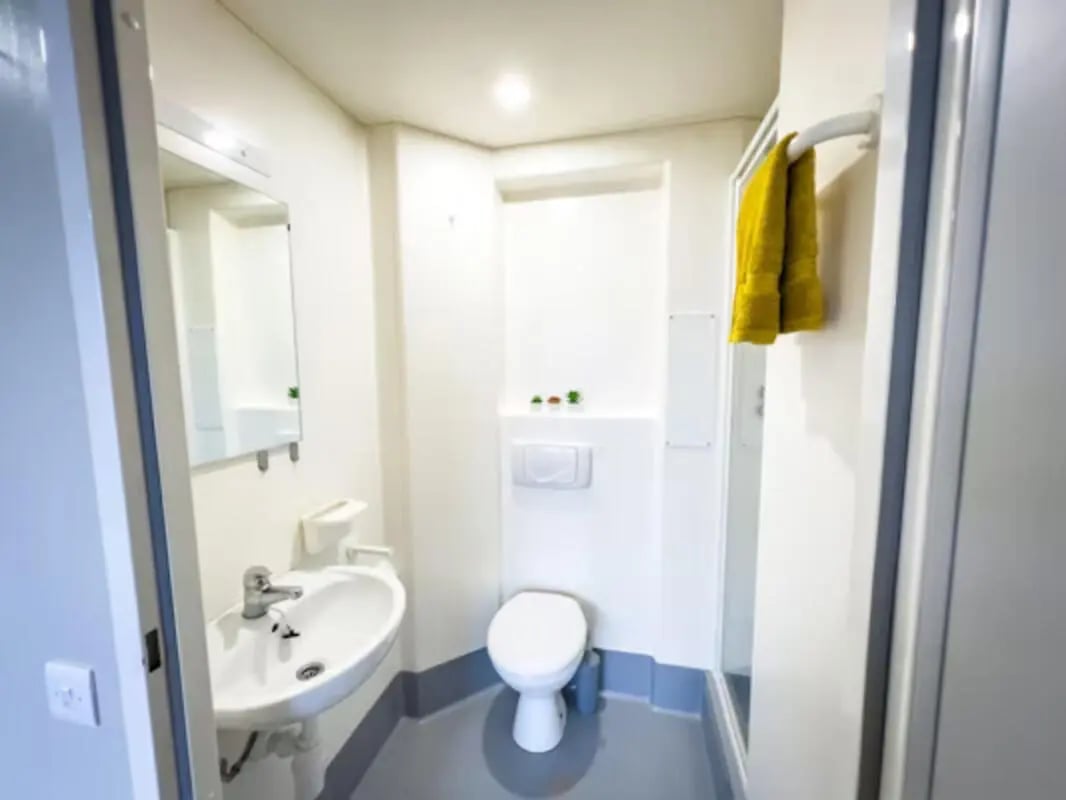 Sink toilet shower with yellow towel Bathroom at Panmure Court in Edinburgh Student Accommodation