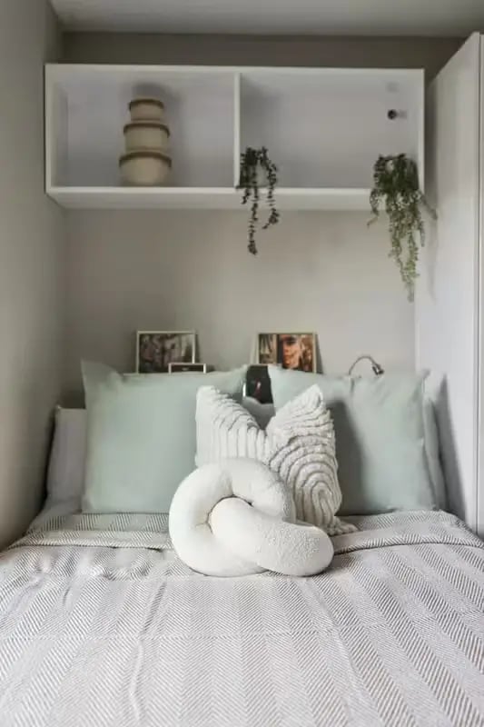 Bed with pillows plants and shelves Bedroom at Talbot Point in Nottingham Student Accommodation