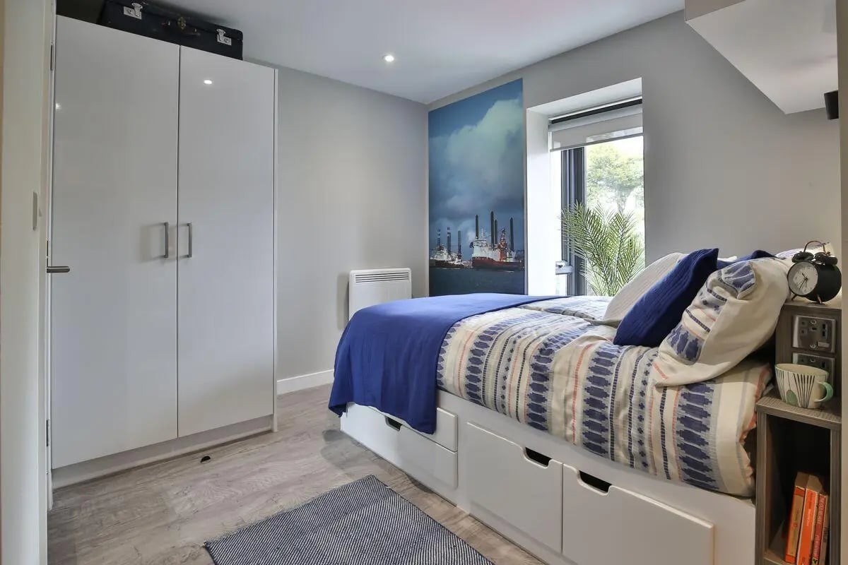 Wardrobe bed with drawers and artwork bedroom at Ocean View in Falmouth Student Accommodation