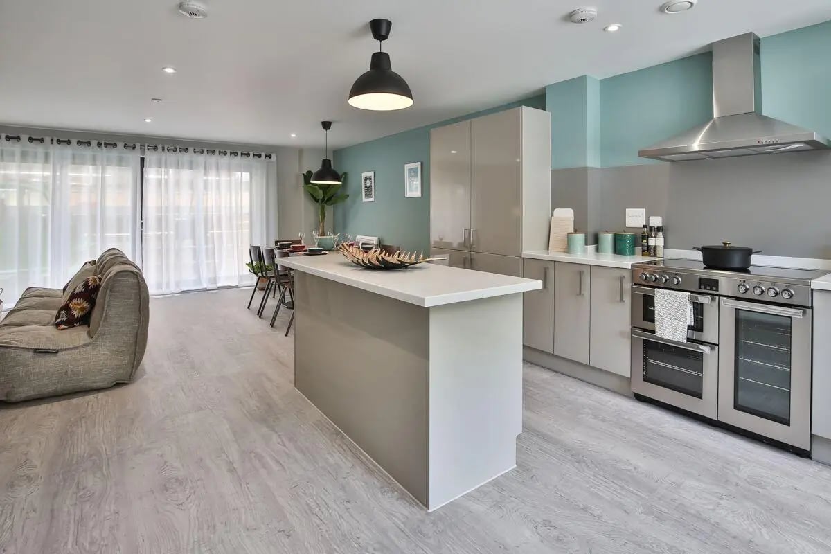 Sofa island kitchen cabinets oven and stove kitchen at Ocean View in Falmouth Student Accommodation