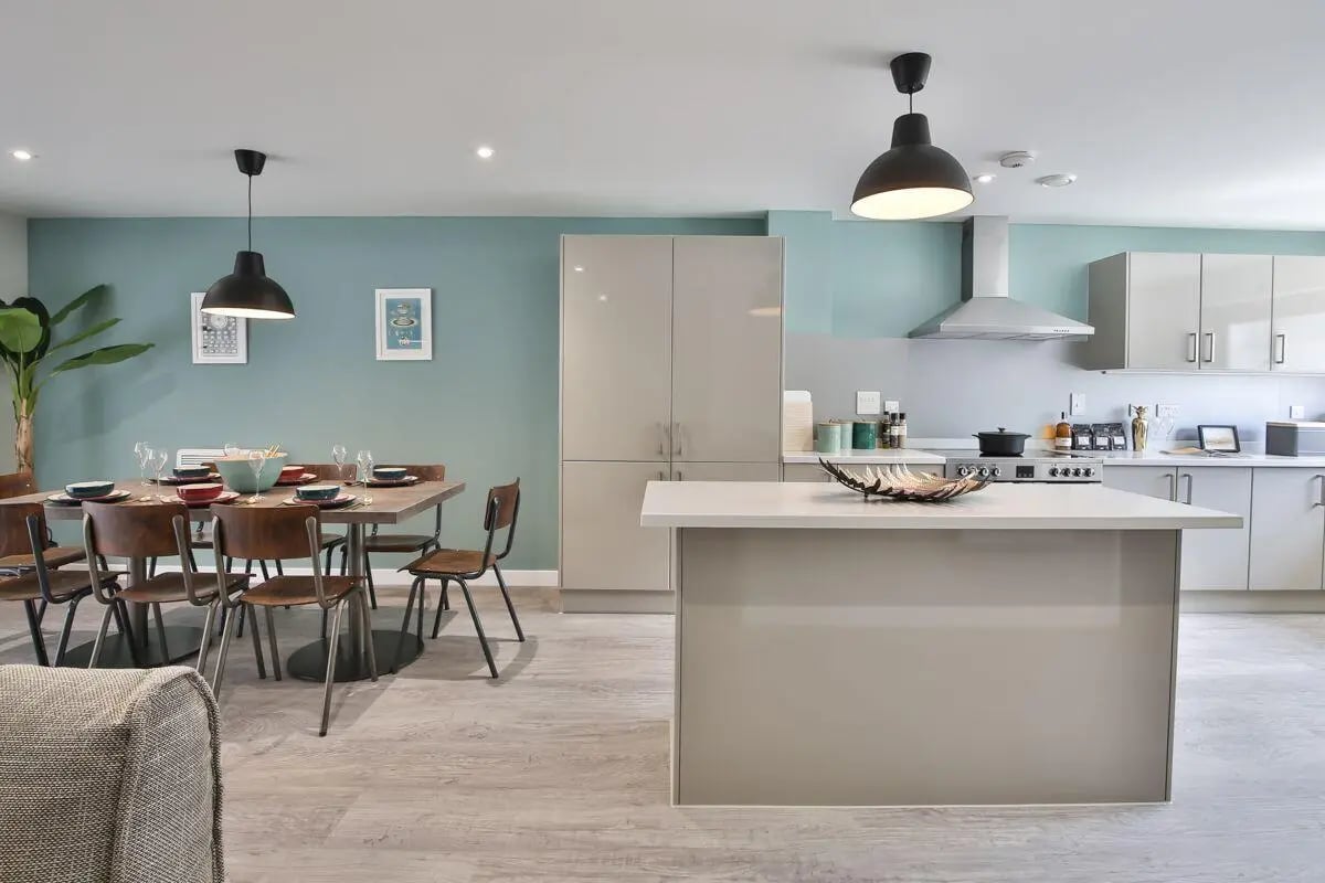 Dining table chairs island kitchen area kitchen at Ocean View in Falmouth Student Accommodation