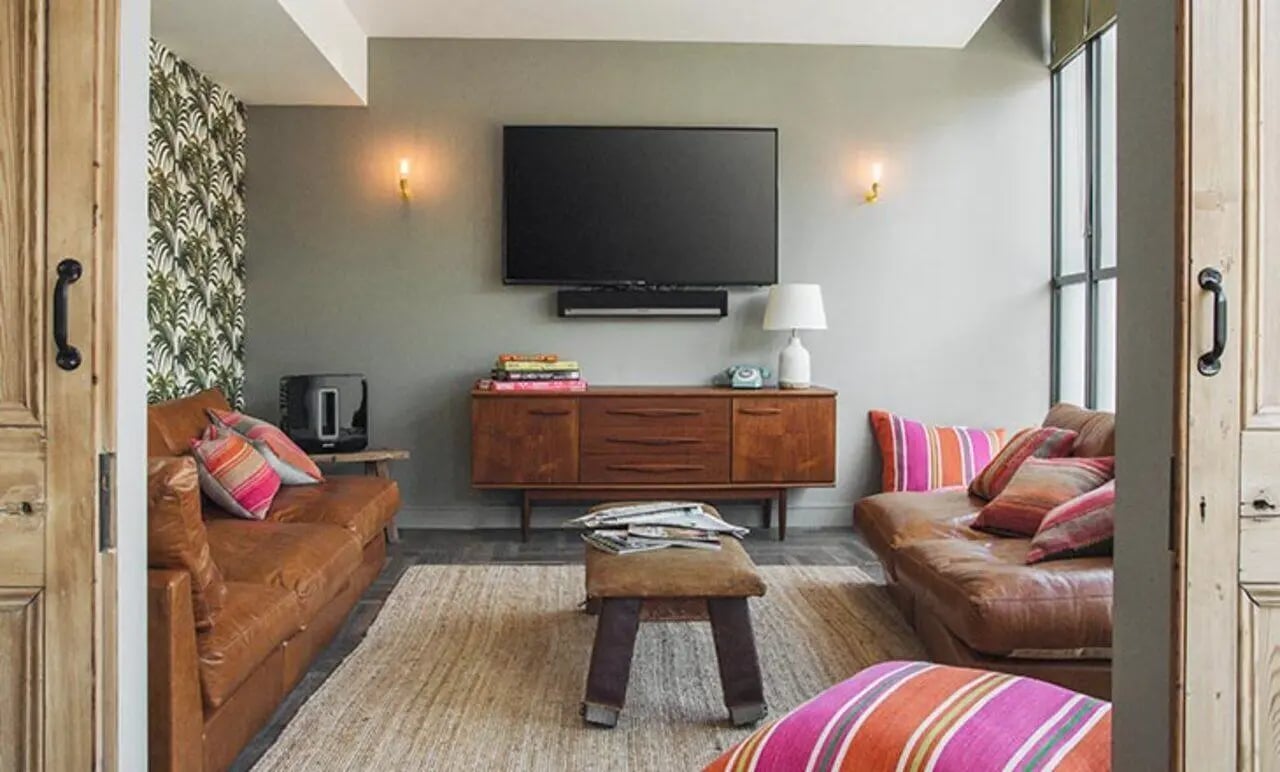Two leather sofas with patterned pillows living room at Canvas The Parade in Cardiff Student Accommodation