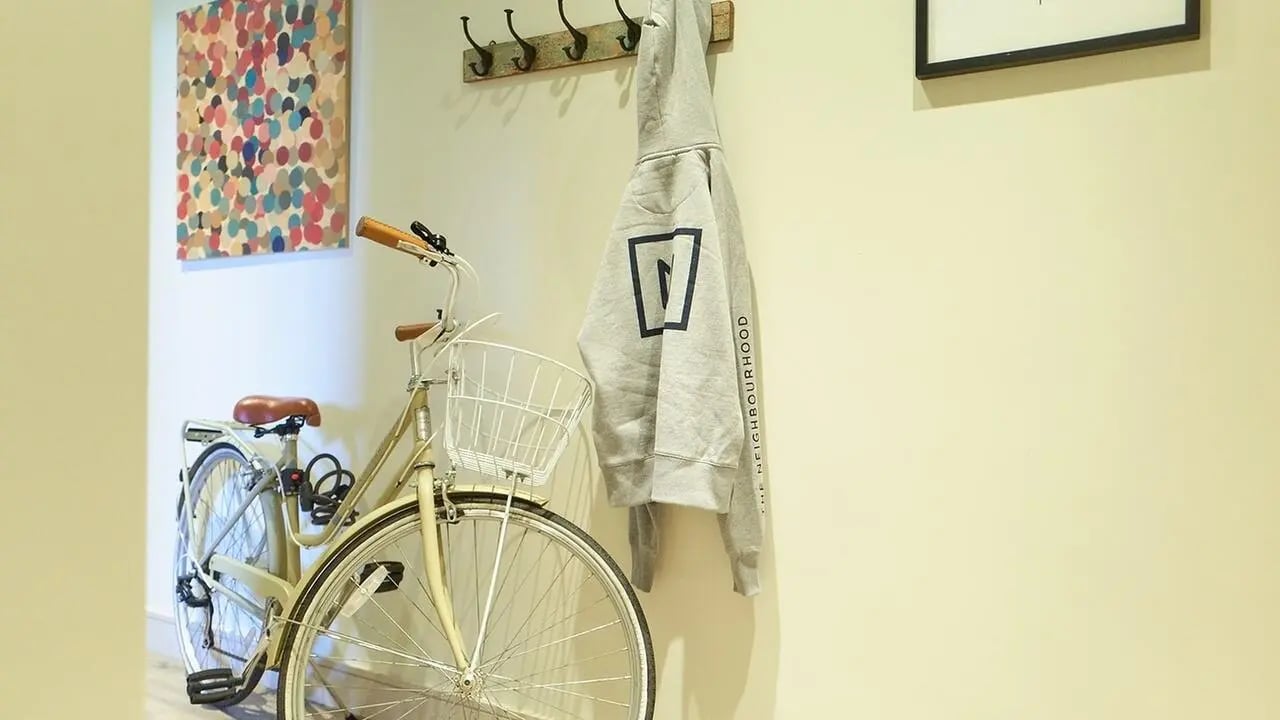 Bicycle and gray hoodie hanging entry area at Canvas The Parade in Cardiff Student Accommodation