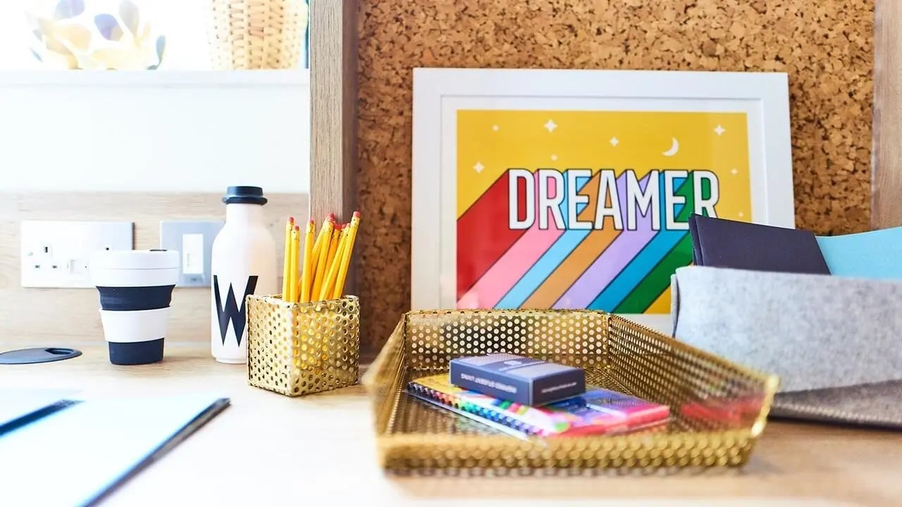 Desk with pencils cup artwork and stationery study area at Canvas The Parade in Cardiff Student Accommodation