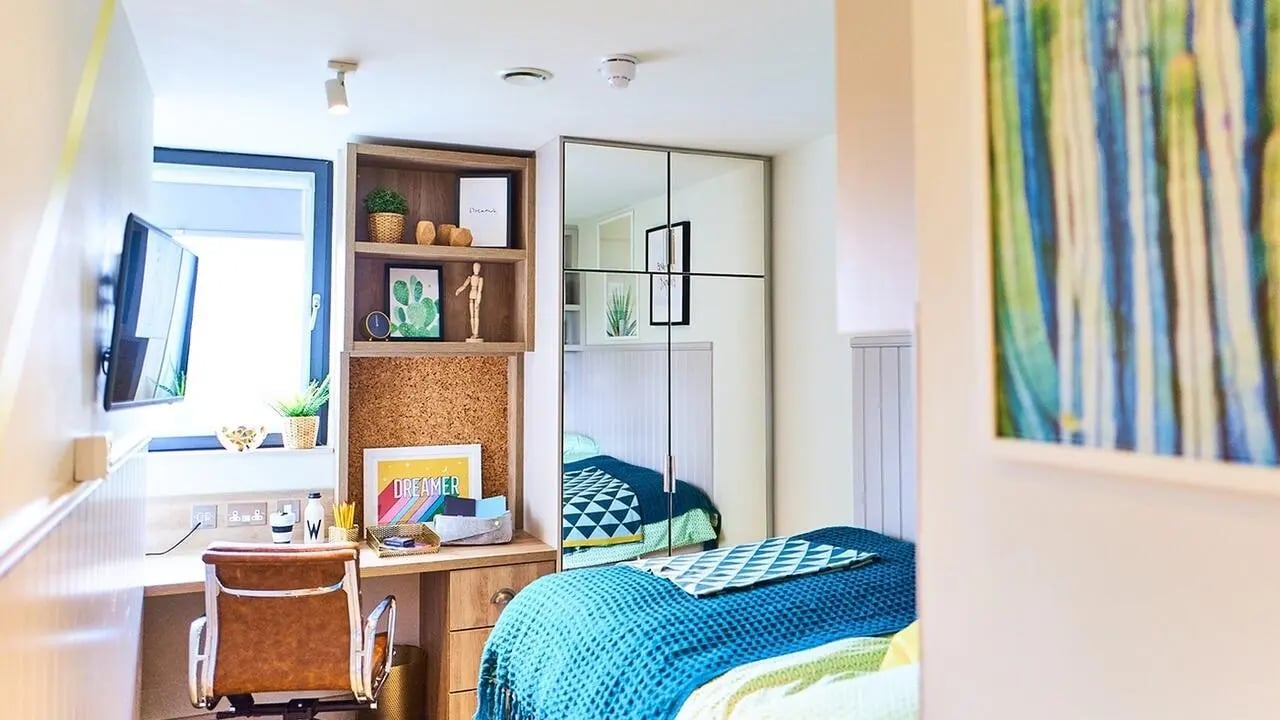 Desk chair television shelves mirror bed Bedroom at Canvas The Parade in Cardiff Student Accommodation