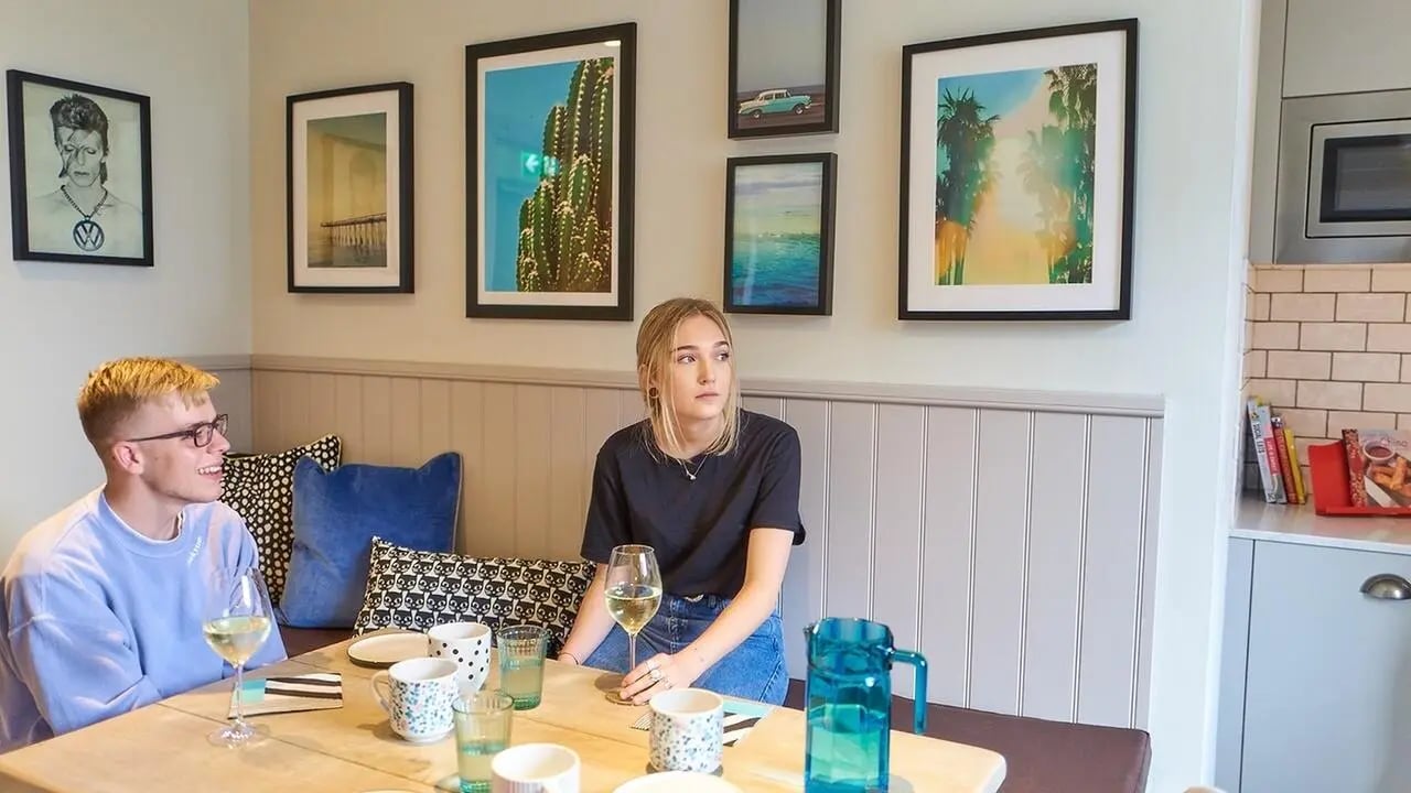 Students at dining table with artwork dining area at Canvas The Parade in Cardiff Student Accommodation