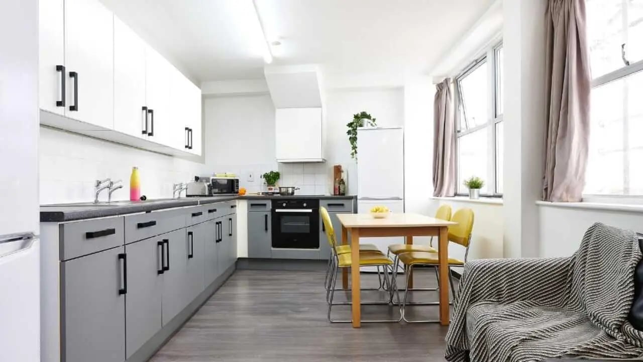 Modern kitchen with dining table and sofa kitchen area at Northernhay House in Exeter Student Accommodation