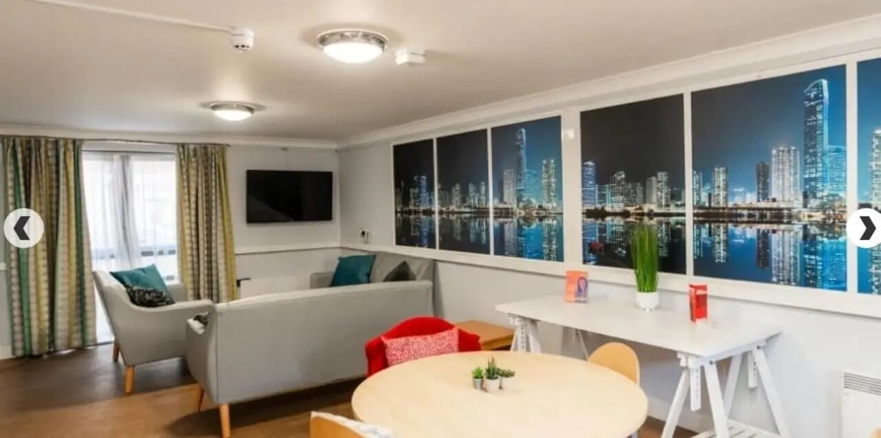 Sofas chairs table and skyline art living area at Coopers Court in London Student Accommodation