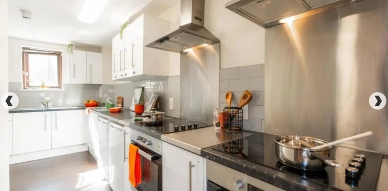 White kitchen cabinets sink stovetop and appliances kitchen at Coopers Court in London Student Accommodation