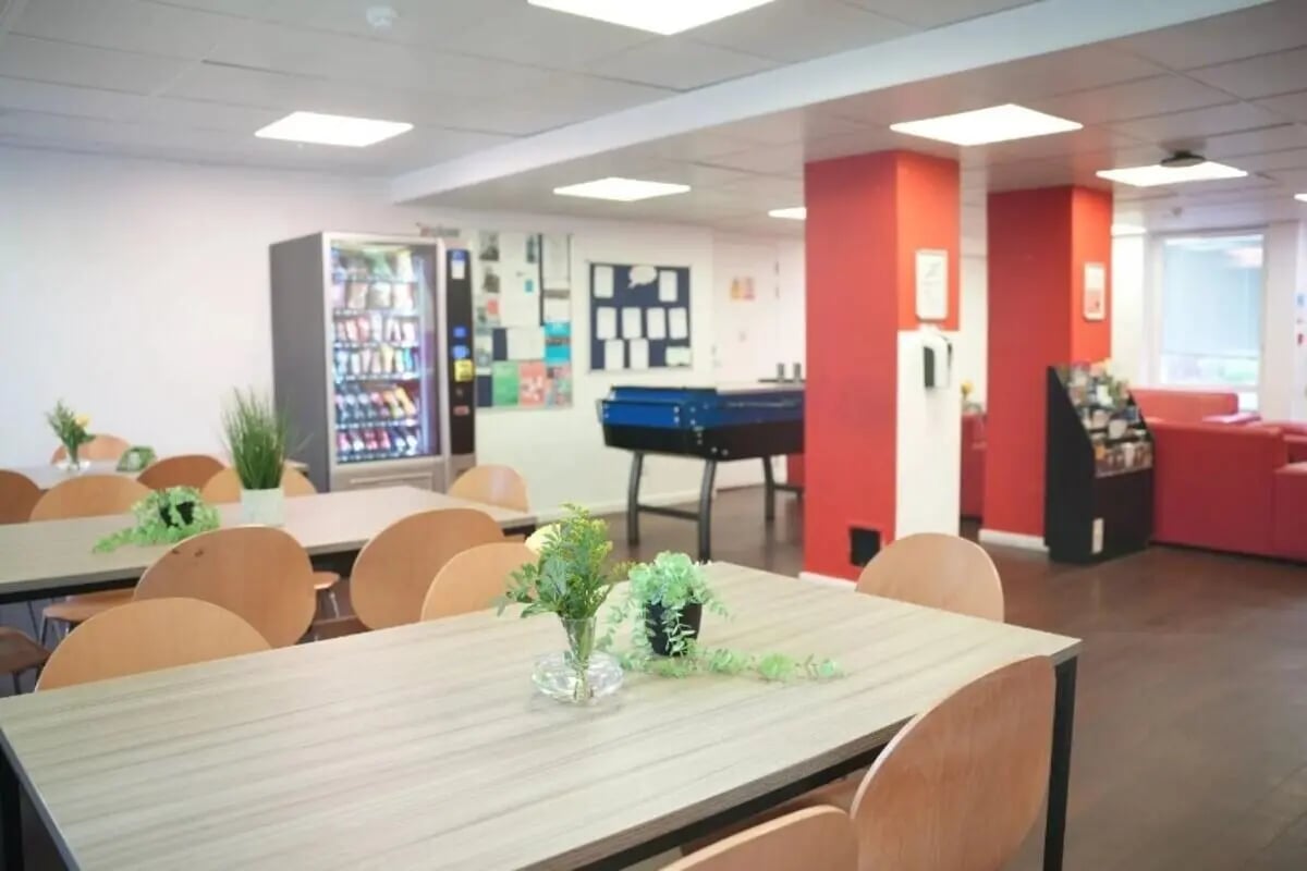 Vending machine table foosball chairs common area at Dinwiddy House in London Student Accommodation