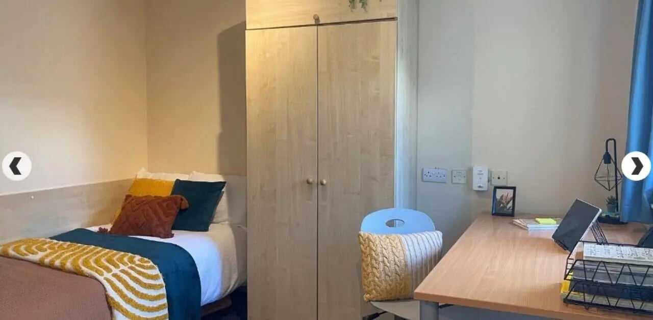 Bed desk wardrobe and chair bedroom at Dinwiddy House in London Student Accommodation