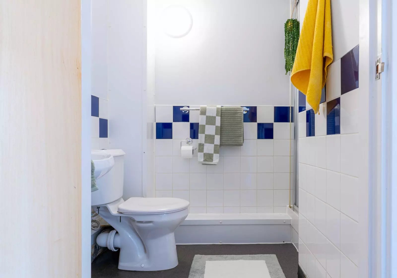 Toilet shower white tiled bathroom at iQ Arkwright House in Bradford Student Accommodation