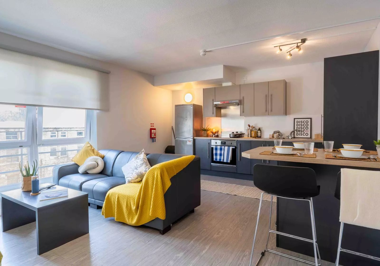 Sofa kitchen area with dining bar Living room at iQ Arkwright House in Bradford Student Accommodation