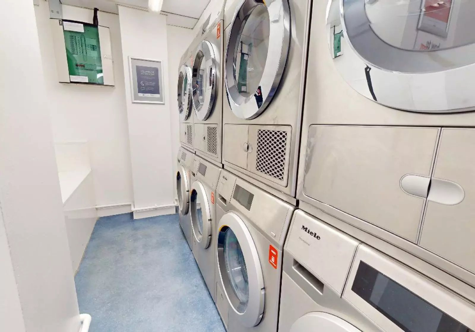 Stacked washing machines and dryers laundry room at iQ Arkwright House in Bradford Student Accommodation