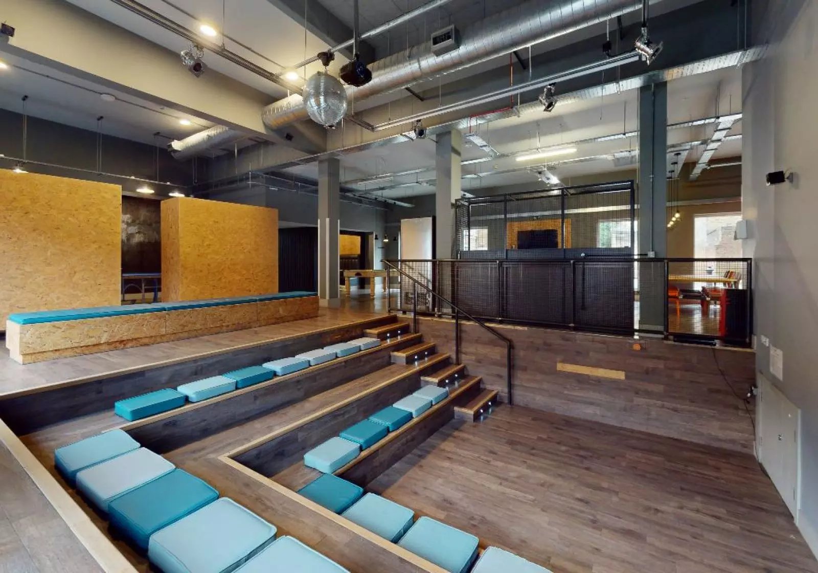 Tiered seating with blue cushions communal area at iQ Arkwright House in Bradford Student Accommodation