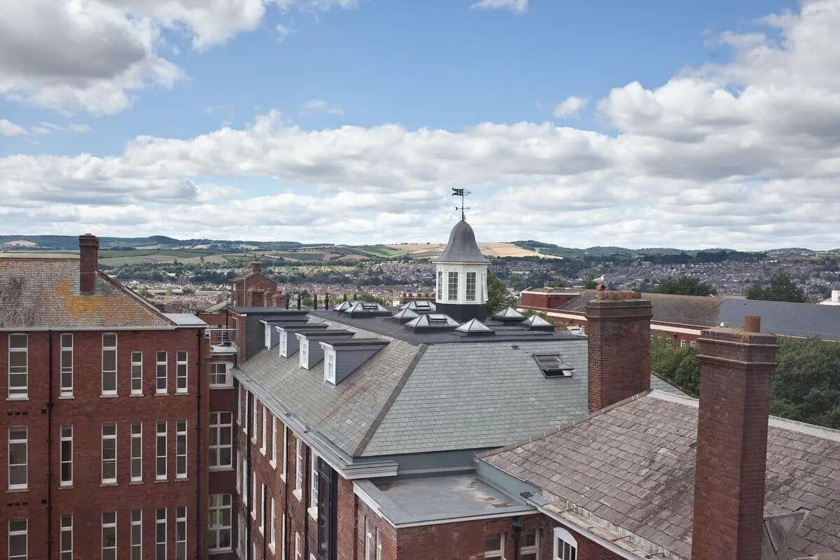 Red brick buildings with tiled roofs and chimneys exterior at Dean Clarke Lofts in Exeter Student Accommodation