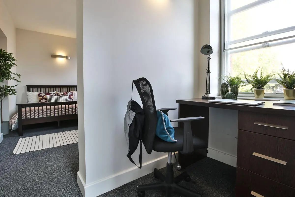 Desk with plants and chair Bedroom living room at Dean Clarke Lofts in Exeter Student Accommodation