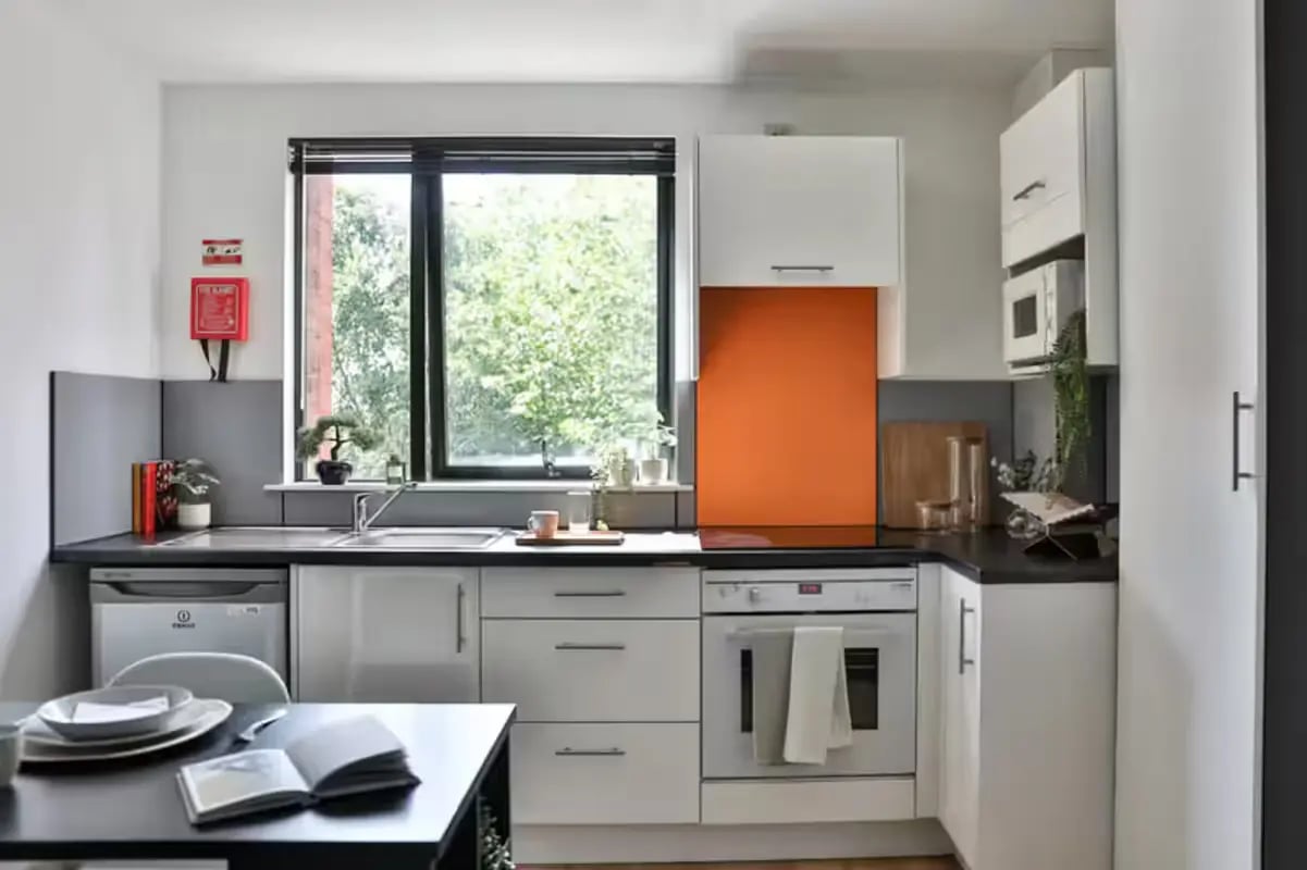 White cabinets oven microwave sink fire extinguisher kitchen at Hayward House in Liverpool Student Accommodation