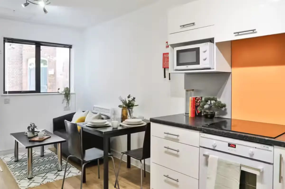 Dining table couch and kitchen area studio apartment at Hayward House in Liverpool Student Accommodation