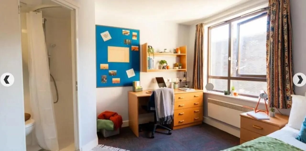 Shower desk chair bulletin board bedroom at Lilian Knowles House in London Student Accommodation