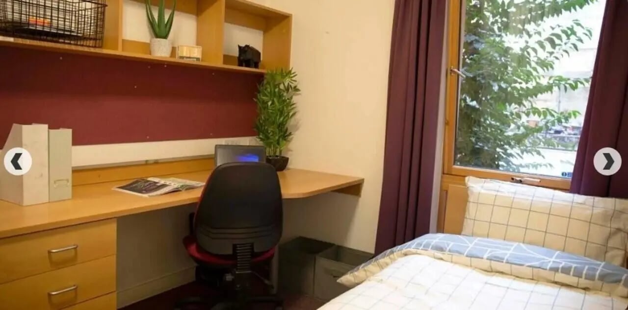 Desk chair laptop shelves bed bedding Bedroom at Lilian Knowles House in London Student Accommodation