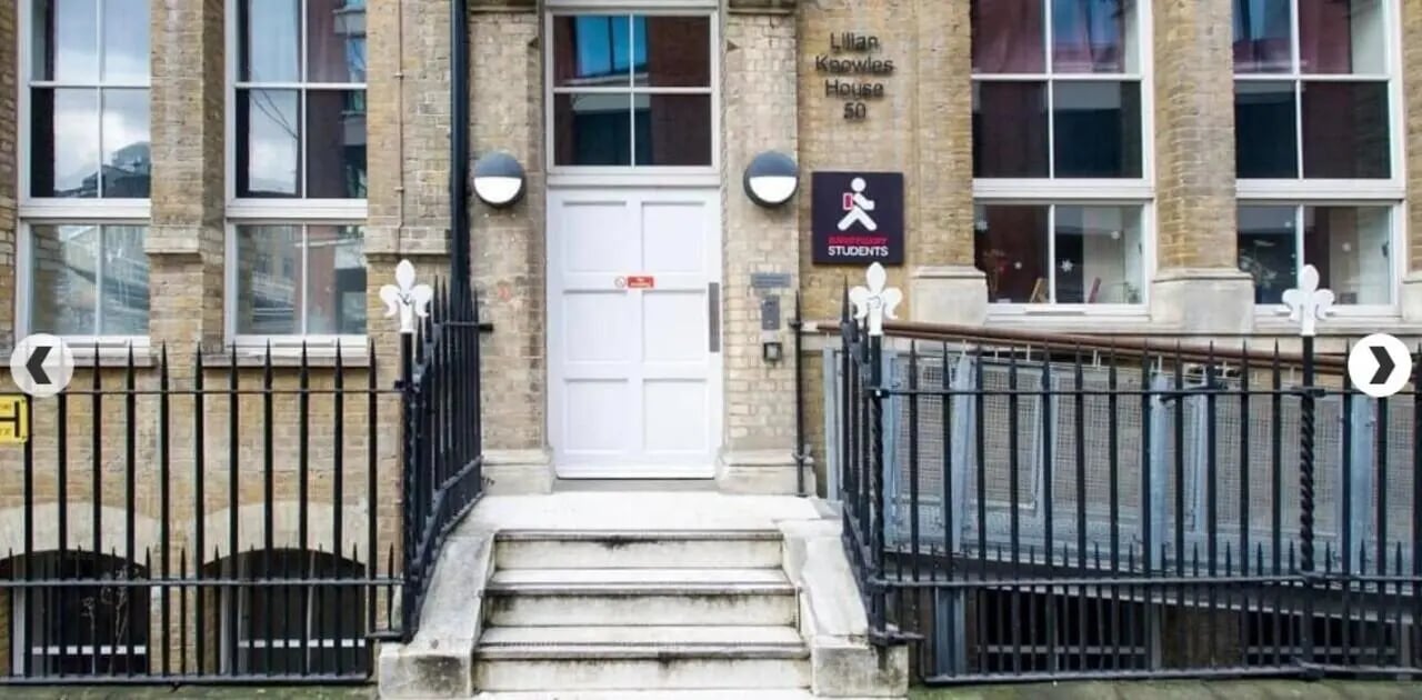Brick building entrance with white door and windows exterior at Lilian Knowles House in London Student Accommodation