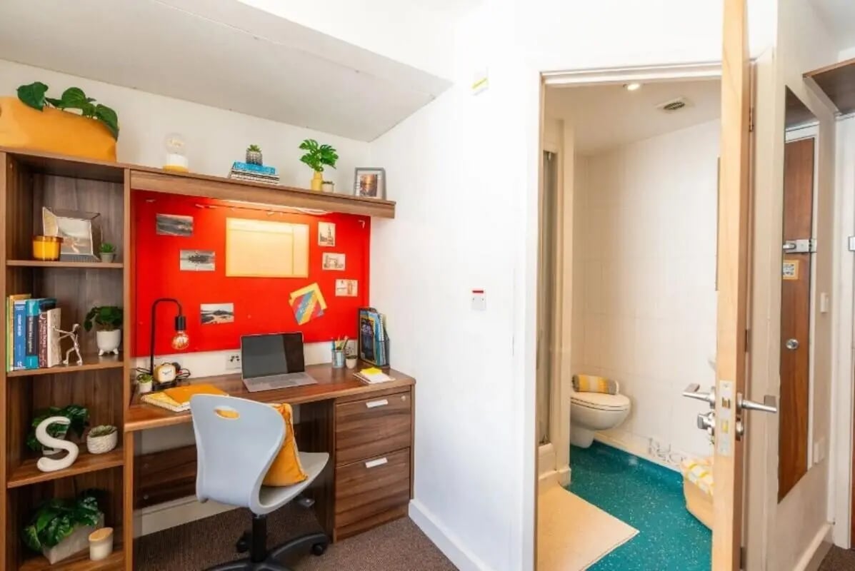 Desk chair laptop shelves bulletin board bathroom at The Craft Building in London Student Accommodation