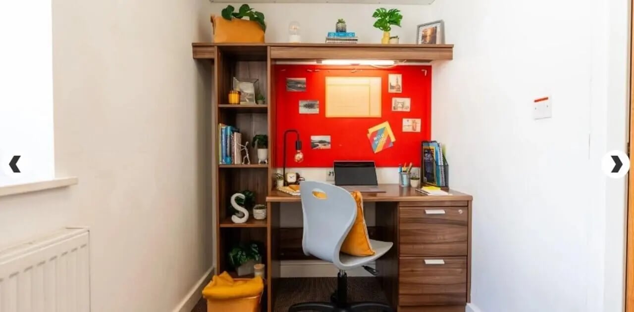 Desk with laptop shelves and red bulletin board study area at The Craft Building in London Student Accommodation