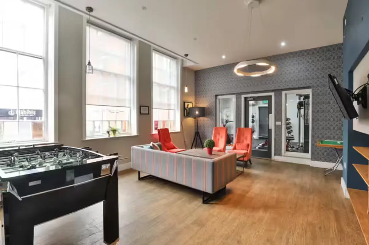 Foosball table sofas chairs gym area living room at Art School Lofts in Liverpool Student Accommodation