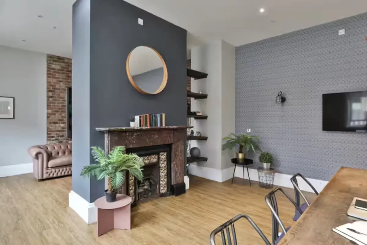 Fireplace Chesterfield sofa patterned wall TV living room at Art School Lofts in Liverpool Student Accommodation