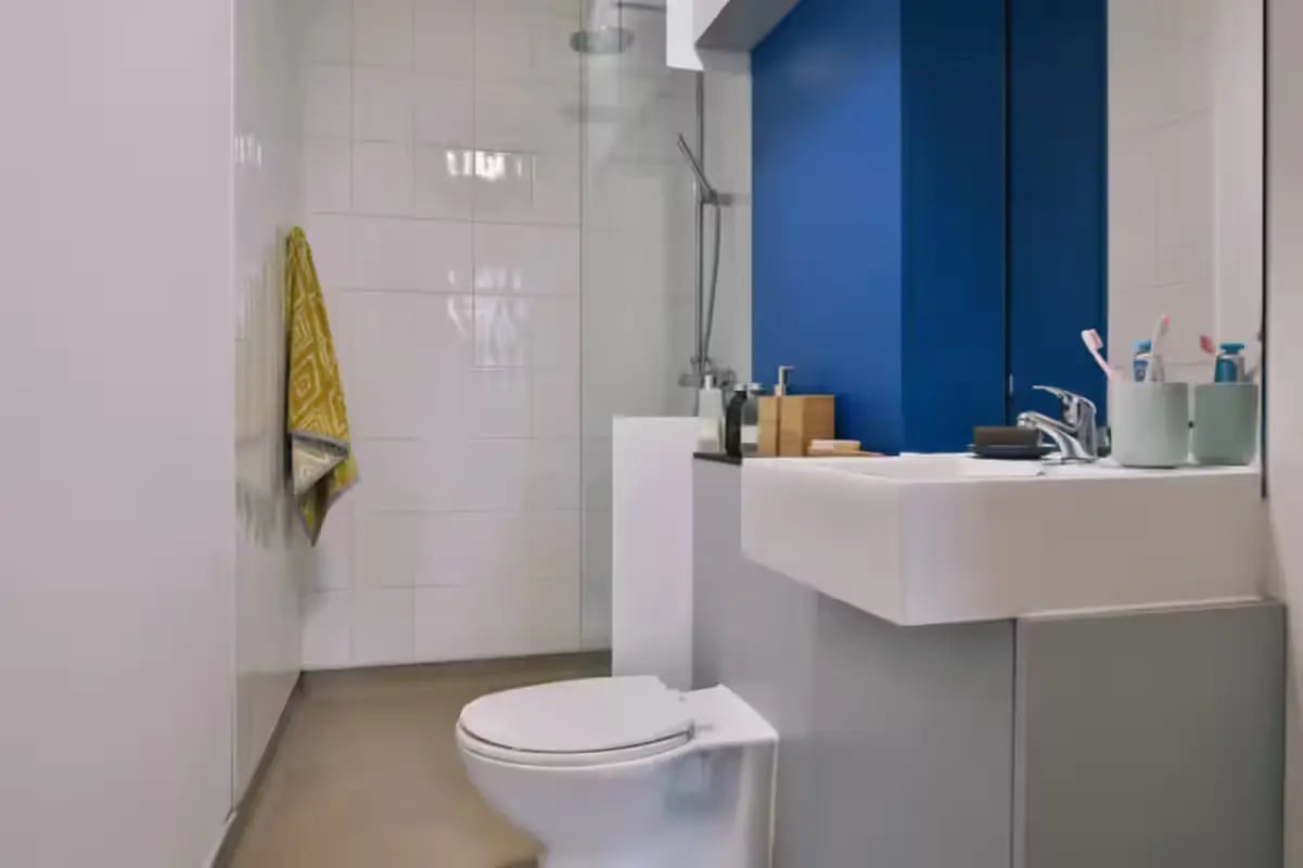 Toilet sink and shower with yellow towel bathroom at Art School Lofts in Liverpool Student Accommodation