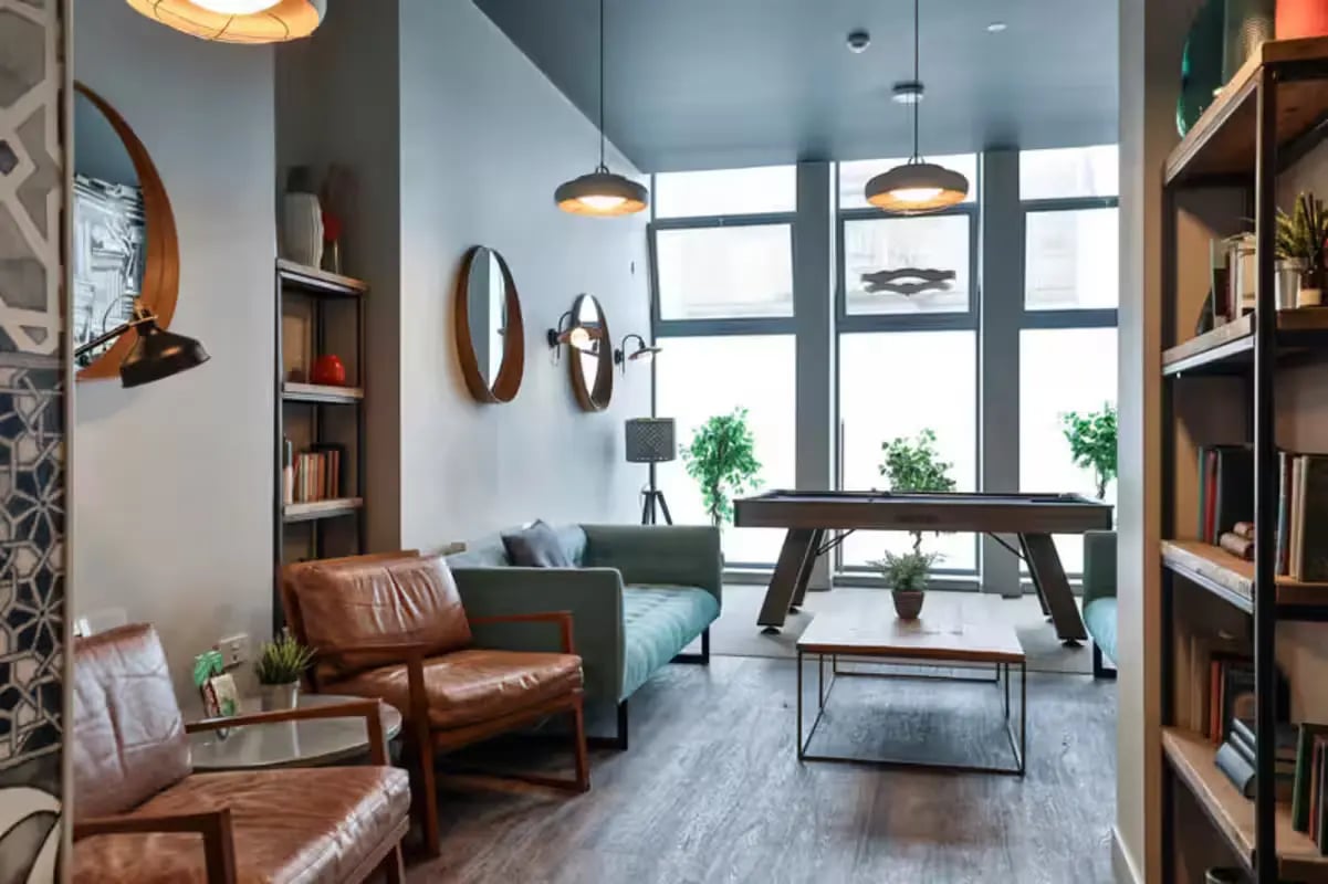 Sofa pool table chairs and bookshelves lounge area at Buccleuch Street in Edinburgh Student Accommodation