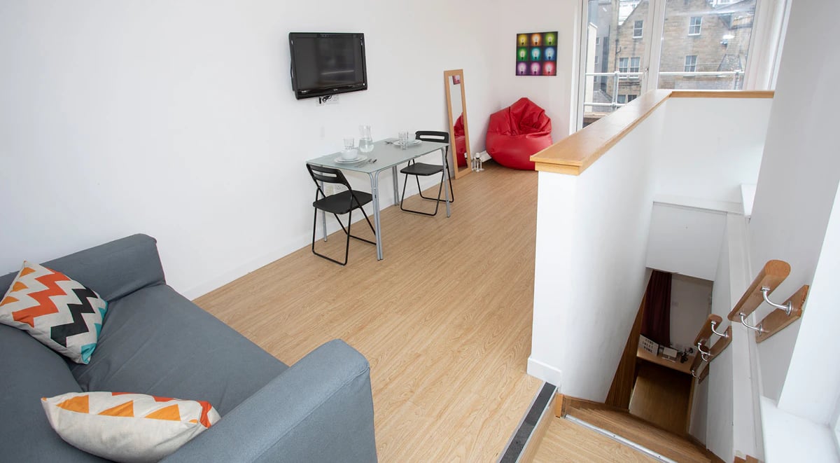 Couch table chairs TV beanbag stairs living room at 200 Cowgate in Edinburgh Student Accommodation