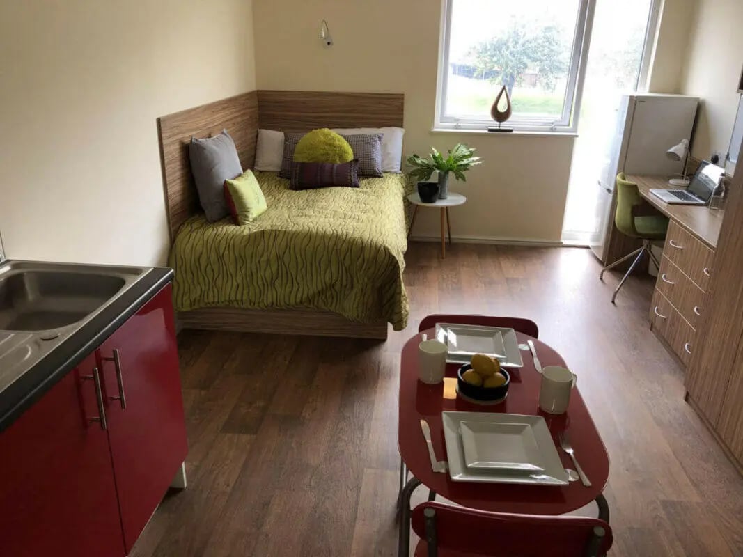 Bed kitchen desk and table student studio room at Falkland House in Liverpool Student Accommodation