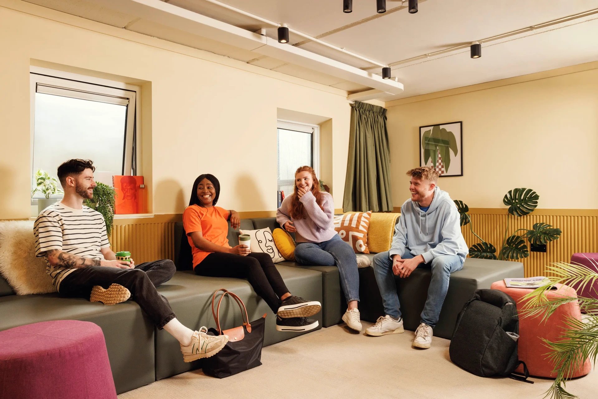 Four students sitting on a sofa living room at The Bridge House in Edinburgh Student Accommodation