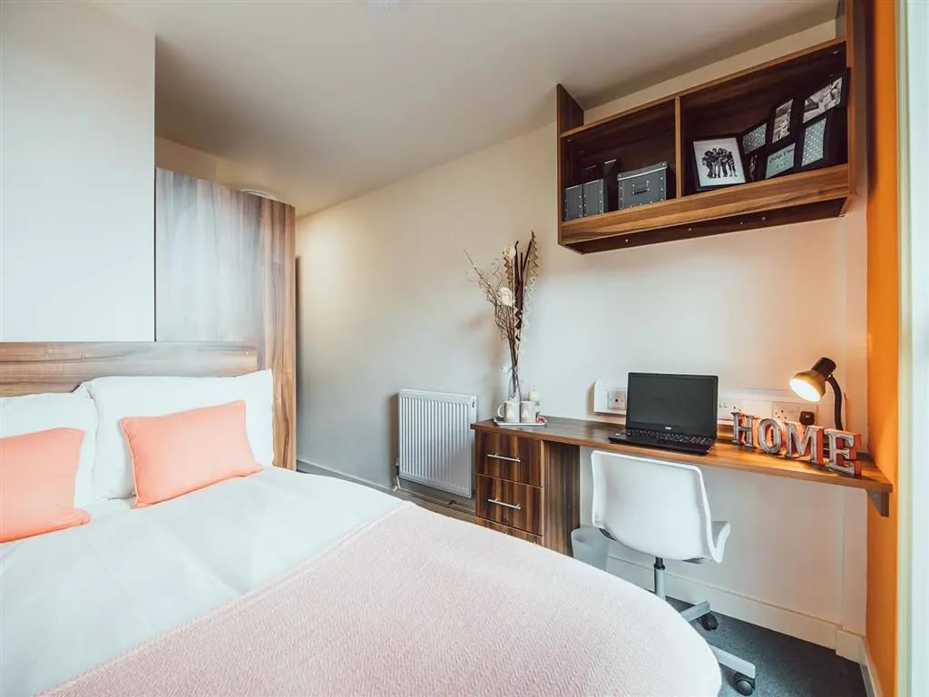 Bed with desk and laptop bedroom at Lomax Halls in Stoke-On-Trent Student Accommodation